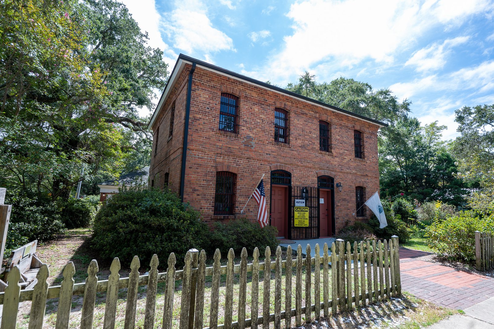 Old Brunswick County Jail Museum with picket fence