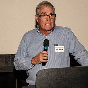Speaker with microphone at a Tuesday Talk