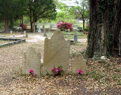 Gravestones decorated with flowers in the burying ground