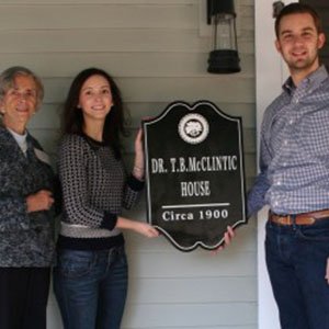 Dr. T. B. McClintic House plaque, circa 1900, held by visitors
