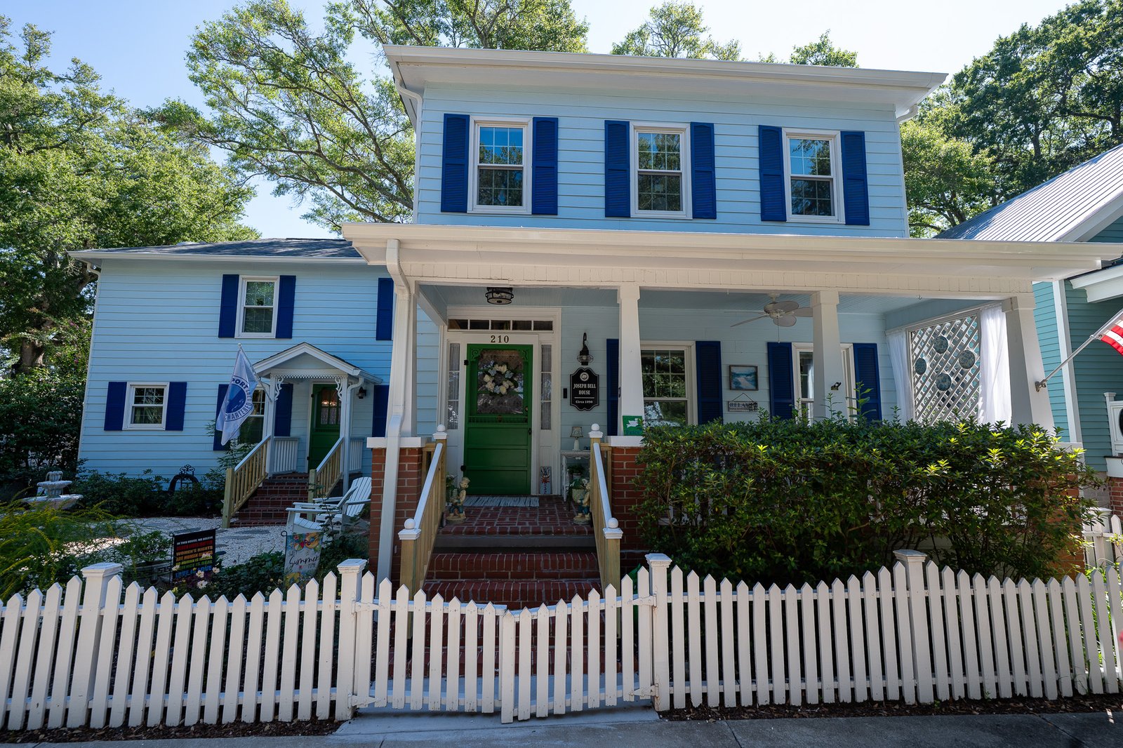 Historic blue house with white picket fence
