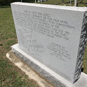 Stone monument with the map of the first 100 lots